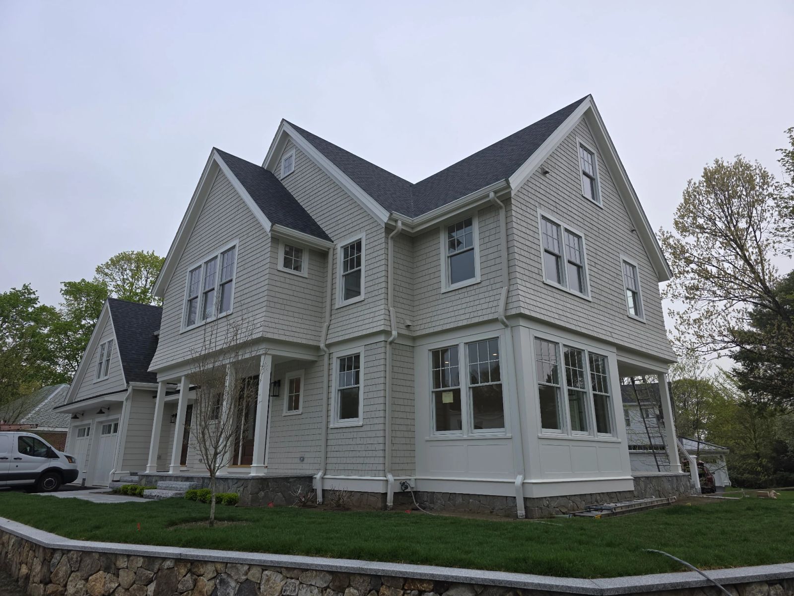 Full exterior repaint of a large shingle-style home