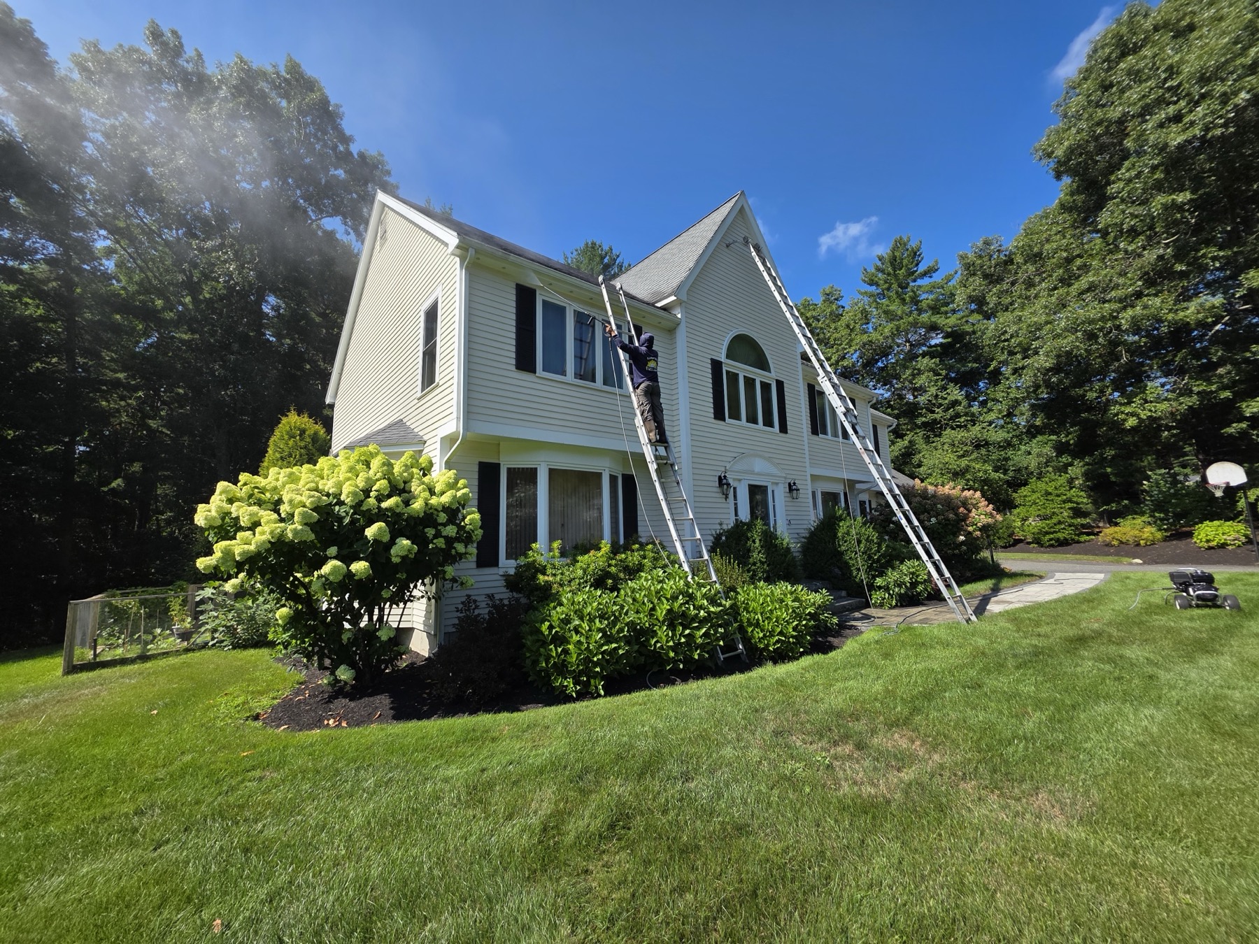 Finished exterior repaint, gray siding with white trim