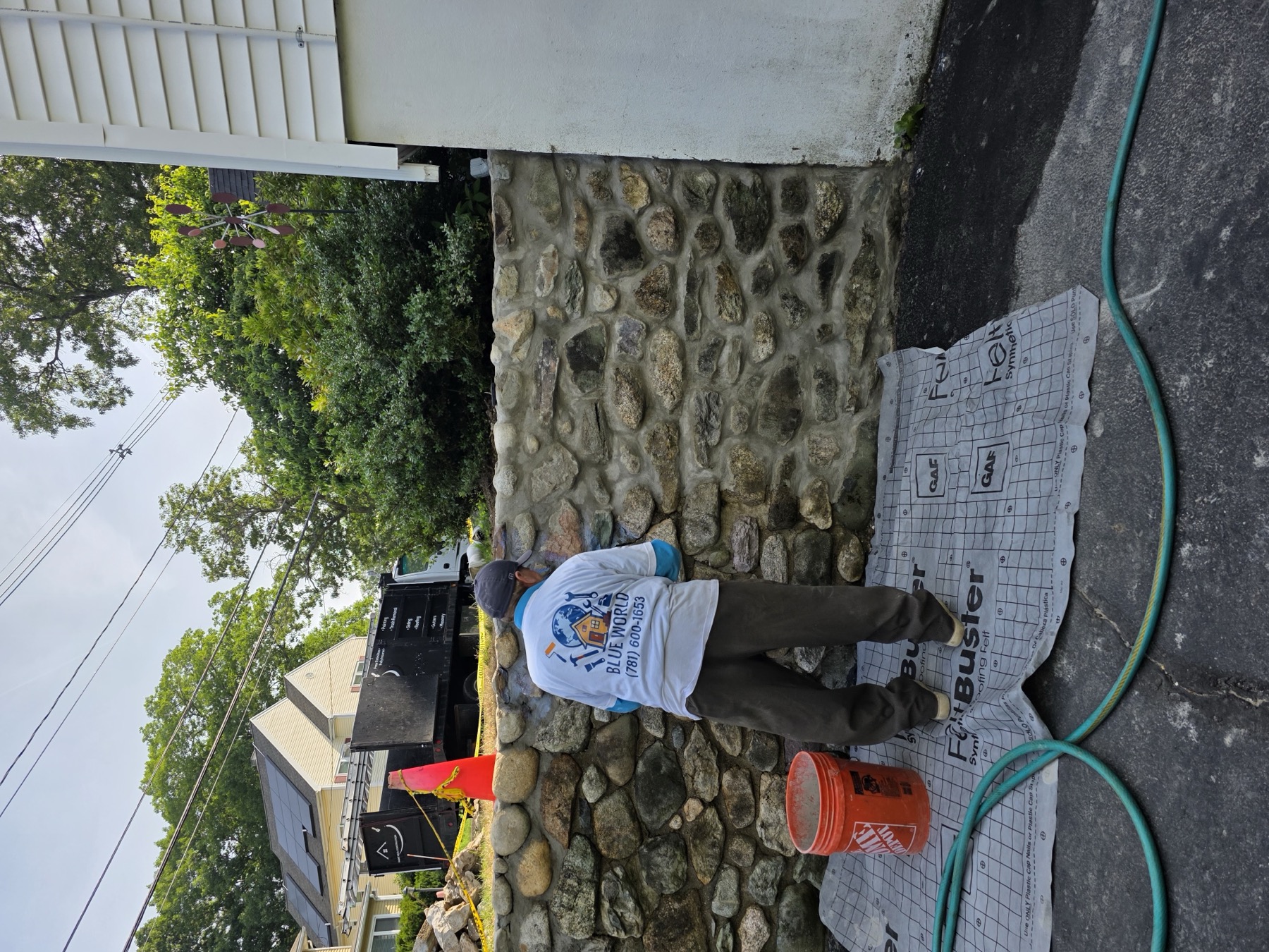 Crew member finishing masonry and stonework detail