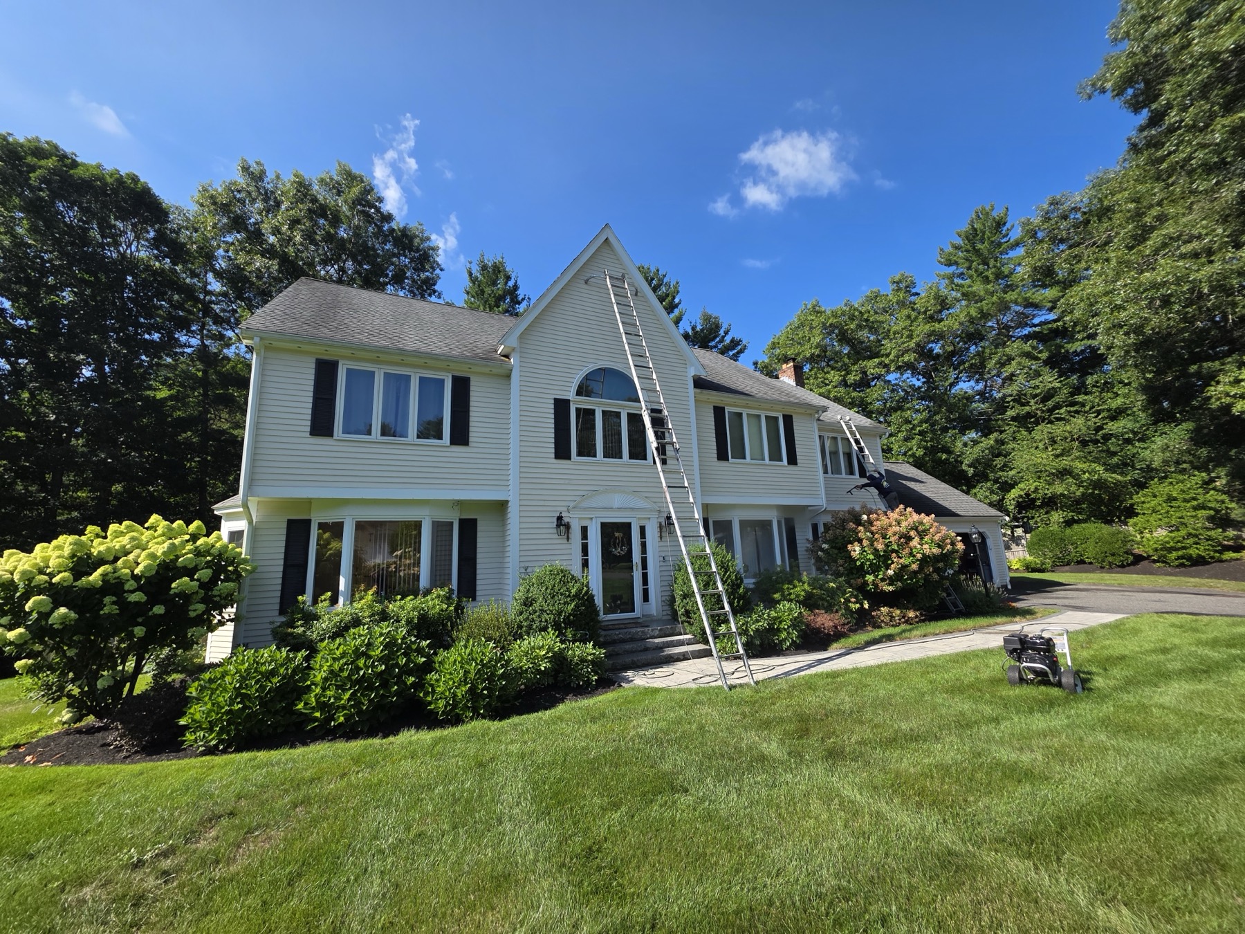 Large colonial home exterior repaint in progress